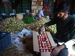 Growers filling boxes with apples at a wholesale market in Srinagar on Friday. (Waseem Andrabi/HT)