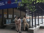 Police officers stand guard outside a closed metro station.