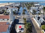In an aerial view, an emergency vehicle drives through coastal floodwaters amid strong waves and high tides generated by Tropical Storm Rachel on October 9, 2026 in Newport Beach, California. 