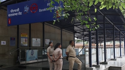 Police officers stand guard outside a closed metro station. (REUTERS)