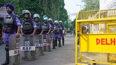 Rapid Action Force (RAF) personnel stand guard near Delhi Police barricades in New Delhi on Saturday. (Representative Image/PTI) Rapid Action Force (RAF) personnel stand guard near Delhi Police barricades in New Delhi on Saturday. (Representative Image/PTI)