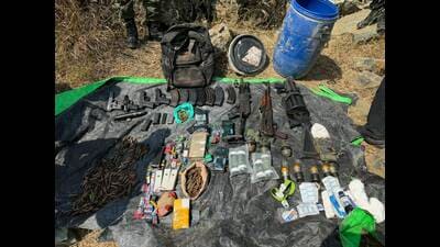 The seized cache of arms from Mukaam Chethar forests in Baramulla’s Sopore on Saturday. (HT Photo)