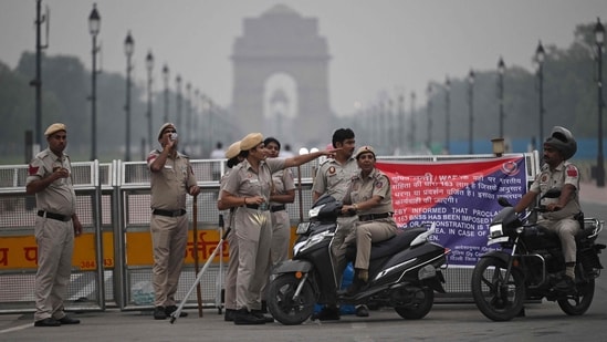 Delhi Police personnel stand guard ahead of a protest by the Cockroach Janata Party (CJP). 