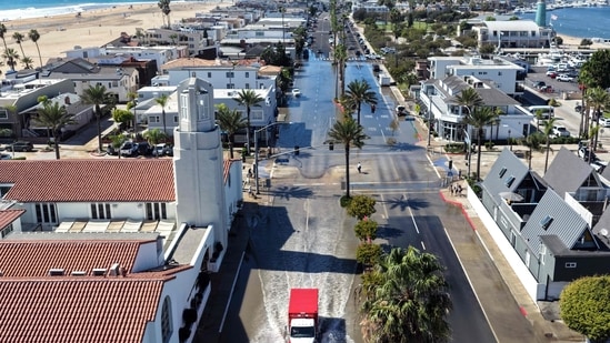 In an aerial view, an emergency vehicle drives through coastal floodwaters amid strong waves and high tides generated by Tropical Storm Rachel on October 9, 2026 in Newport Beach, California. (Getty Images via AFP)