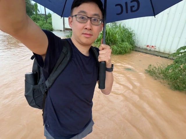 Eric Park traveling on foot through a monsoon in Manila in search of computing resources. Eric Park traveling on foot through a monsoon in Manila in search of computing resources.
