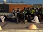 People gather outside a metro station on the road to King Khalid International Airport in Riyadh, Saudi Arabia.