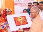 Chief minister Yogi Adityanath interacts with children during the 'Shiksha ki Udaan' initiative on the occasion of the first day of the Navratri festival, in Balrampur on Sunday. (ANI)