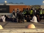 People gather outside a metro station on the road to King Khalid International Airport in Riyadh, Saudi Arabia.