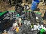 The seized cache of arms from Mukaam Chethar forests in Baramulla’s Sopore on Saturday. (HT Photo)