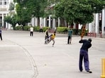Youngsters play cricket on the deserted streets of the Inner Circle in Connaught Place on Sunday morning.