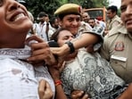Police officers detain a demonstrator from National Students' Union of India (NSUI), outside the Press Club of India, in New Delhi on Sunday.(Reuters)