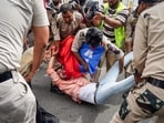A protester being detained at Palika Bazar, Connaught Place, in New Delhi on Sunday. 
