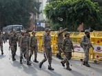 Security personnel arrive for their deployment at a temporary checkpoint near Jantar Mantar.