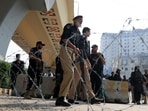 Police guard a road leading to Red Zone, in Peshawar, Khyber Pakhtunkhwa province, Pakistan,