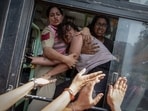 Policewomen try to prevent a detained protestor from escaping in New Delhi on Saturday.