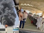 Plumes of smoke rising from Riyadh airport after airstrike (L). Ambulance arrives to take away the injured after attack wounds hundreds.  