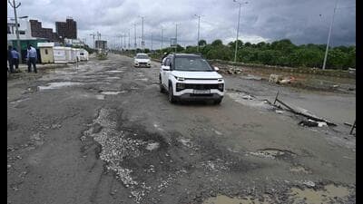 A damaged road in Gomti Nagar Extension, where potholes continue to trouble commuters despite the end of the rainy spell. (Deepak Gupta/HT)