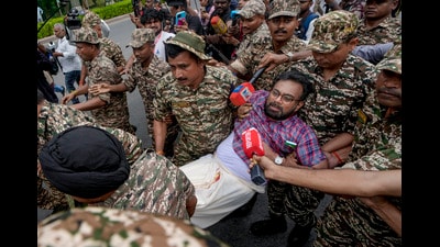 Police personnel detain CPI (M) MP John Brittas in Connaught Place area on Sunday. (PTI) Police personnel detain CPI (M) MP John Brittas in Connaught Place area on Sunday. (PTI)