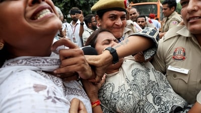 Police officers detain a demonstrator from National Students' Union of India (NSUI), outside the Press Club of India, in New Delhi on Sunday. (Reuters)
