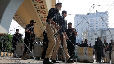 Police guard a road leading to Red Zone, in Peshawar, Khyber Pakhtunkhwa province, Pakistan, (REUTERS)