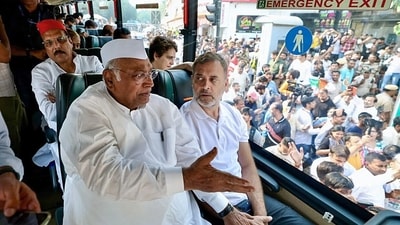 Congress president Mallikarjun Kharge and Lok Sabha LoP Rahul Gandhi sit inside a bus while travelling to Raj Ghat to protest against Chief Election Commissioner Gyanesh Kumar. (ANI Photo)