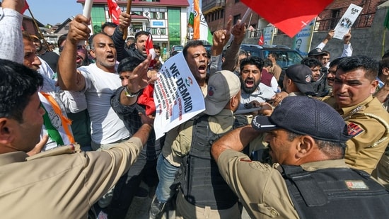 Police personnel stop INDIA bloc alliance party's workers and supporters during a protest against Chief Election Commissioner Gyanesh Kumar, in Srinagar on Saturday. 
