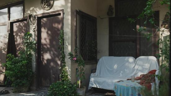 In the morning, the gates in the neighbourhood are left open for newspaper vendors, and a garden chair is set beside its side table. (Courtesy: Ishwar Prasad)