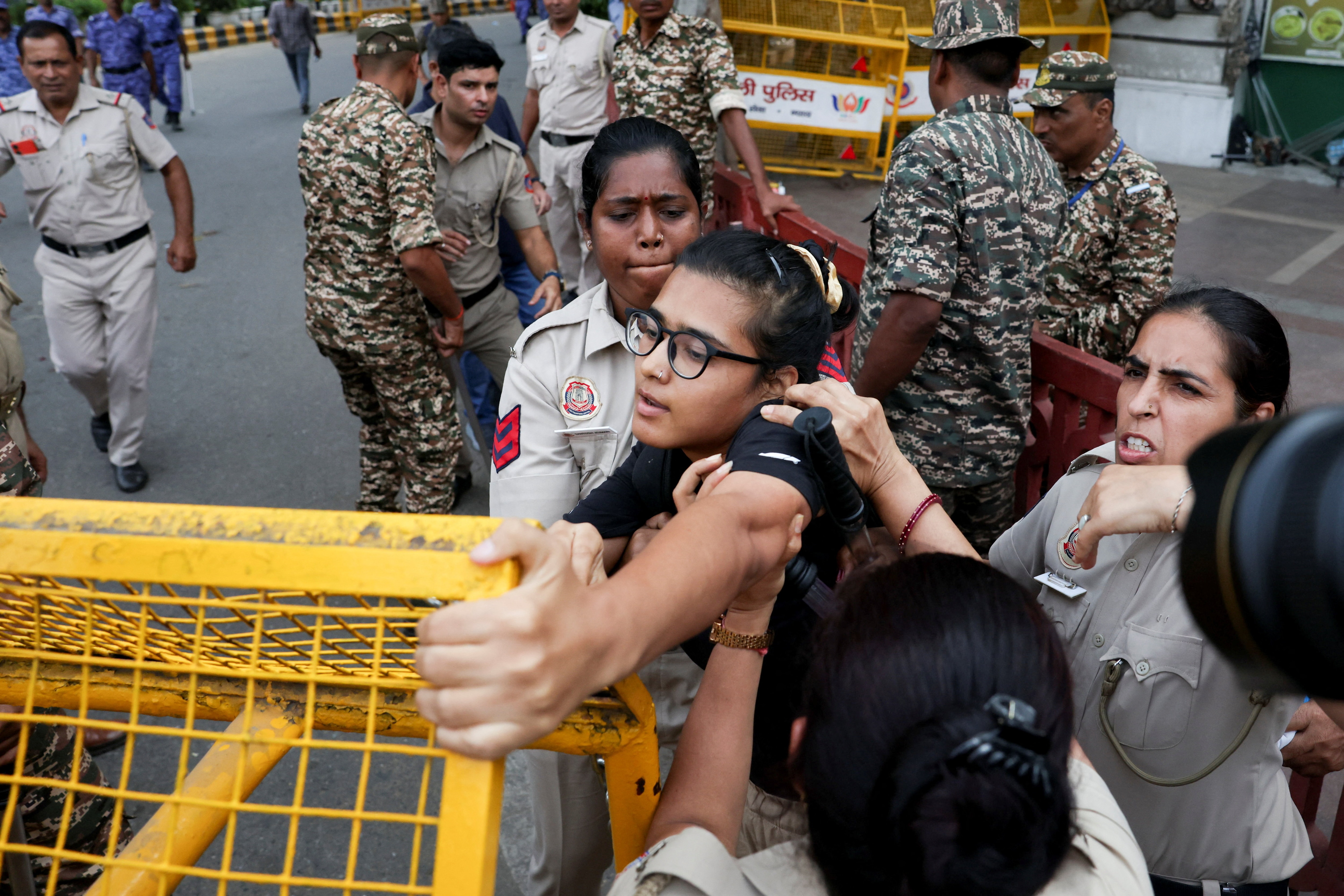 Police officers scuffle with national president of the All India Students' Association (AISA) Neha Bora, as she is detained during a protest demanding the resignation of India's Chief Election Commissioner Gyanesh Kumar, in New Delhi, October 11, 2026. (REUTERS)