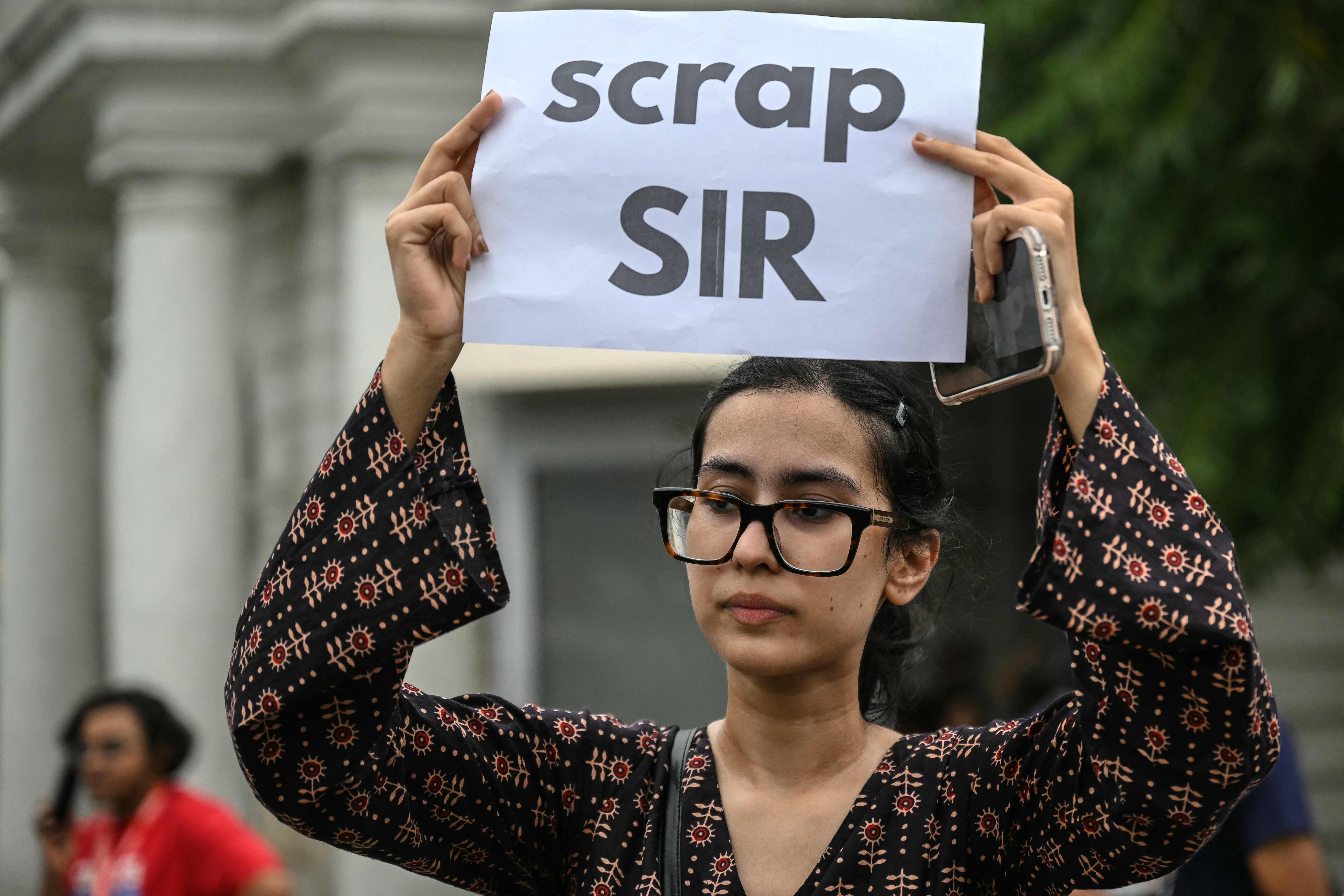 A demonstrator holds a placard during a protest demanding the resignation of India's Chief Election Commissioner Gyanesh Kumar over alleged voter roll irregularities linked to the "special intensive revision" (SIR), near Jantar Mantar in New Delhi on October 11, 2026. (AFP) A demonstrator holds a placard during a protest demanding the resignation of India's Chief Election Commissioner Gyanesh Kumar over alleged voter roll irregularities linked to the "special intensive revision" (SIR), near Jantar Mantar in New Delhi on October 11, 2026. (AFP)