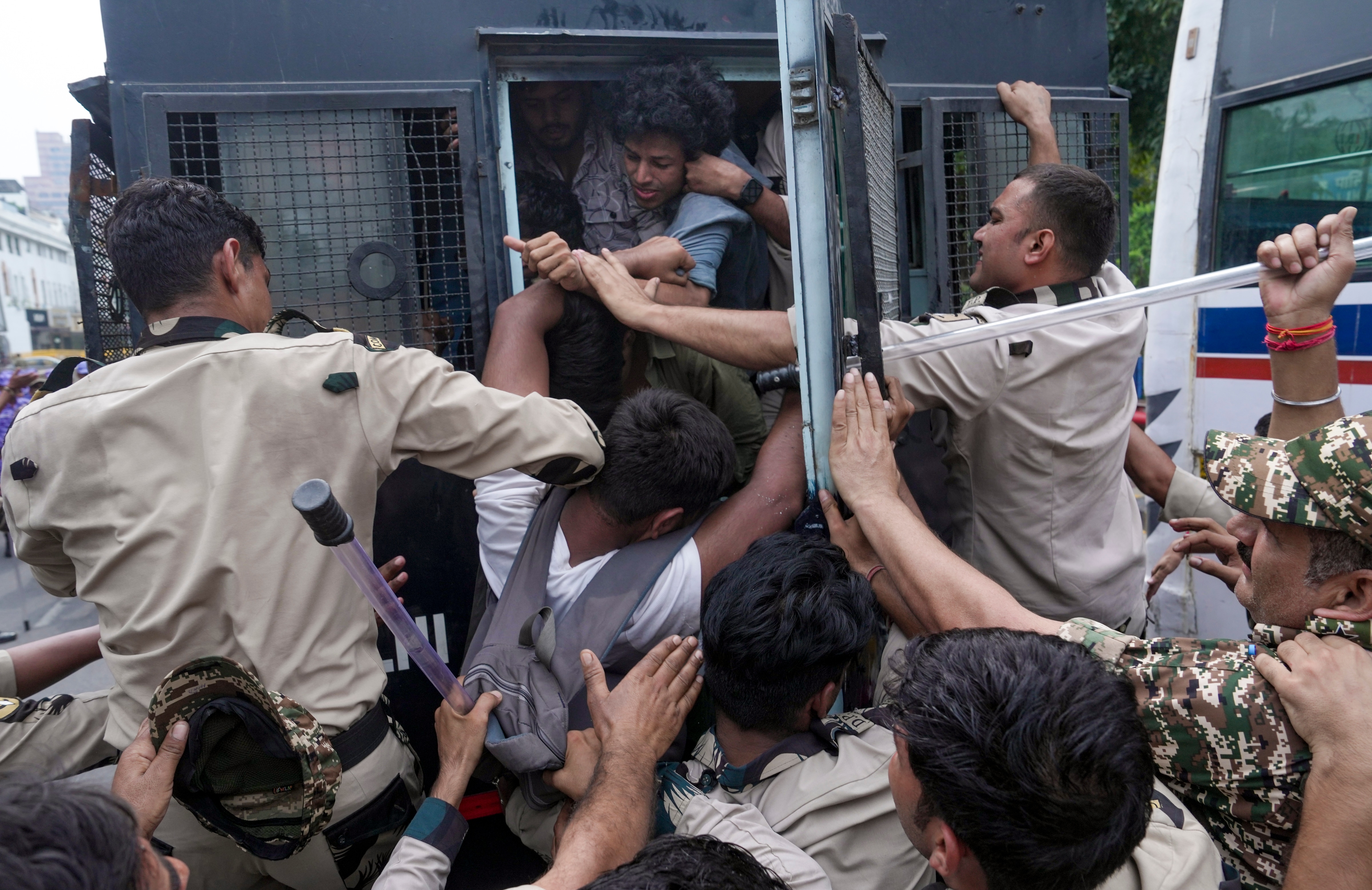 Police personnel detain Students' Federation of India (SFI) activists at the Connaught Place area on Sunday. (PTI) Police personnel detain Students' Federation of India (SFI) activists at the Connaught Place area on Sunday. (PTI)