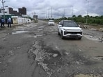 A damaged road in Gomti Nagar Extension, where potholes continue to trouble commuters despite the end of the rainy spell. (Deepak Gupta/HT)