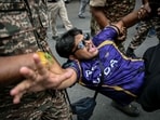 Security personnel detain a demonstrator during a protest demanding the resignation of India's Chief Election Commissioner Gyanesh Kumar over alleged voter roll irregularities linked to the "special intensive revision" (SIR), near Jantar Mantar in New Delhi on October 11.