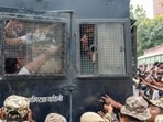 Police personnel detain protestors amid continued demonstration in Connaught Place area on Sunday. (PTI)
