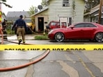 ERIE, PENNSYLVANIA - OCTOBER 10: Firefighters clean blood from outside the home at 722 Perry Street where 9 members of a family were killed in an apparent domestic dispute on October 10, 2026 in Erie, Pennsylvania. (Photo by JEFF SWENSEN / GETTY IMAGES NORTH AMERICA / Getty Images via AFP)