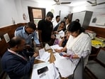 Voters arrive at a voter center to seek clarification and make correction to their SIR Forms at Laxmi Devi School Sadar Bazar, in New Delhi.