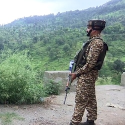 Security personnel stand guard along the Rajouri-Poonch National Highway in file photo.