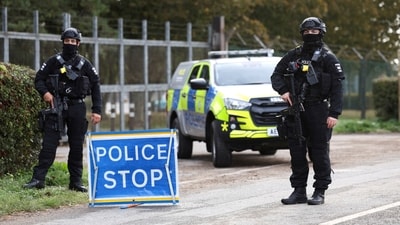 Armed police officers stand guard on a road outside the perimeter of the RAF Fairford airbase, after police declared a major incident at the base last month men. (REUTERS)