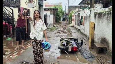 Residents stand amid waterlogged streets with a toppled two-wheeler after heavy rain triggered flooding in Bohri and Anand Nagar area, in Jammu on Sunday. (ANI Video Grab) Residents stand amid waterlogged streets with a toppled two-wheeler after heavy rain triggered flooding in Bohri and Anand Nagar area, in Jammu on Sunday. (ANI Video Grab)