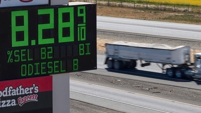 A semi drives past a sign advertising the price of diesel along Interstate 5 in Williams, Calif., Sept. 28.