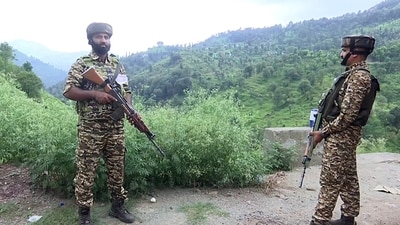 Security personnel stand guard along the Rajouri-Poonch National Highway in file photo. (ANI Video Grab)