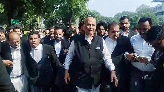 Senior Advocate and Congress MP Abhishek Manu Singhvi, along with lawyers, heads to the Supreme Court in New Delhi on Monday.