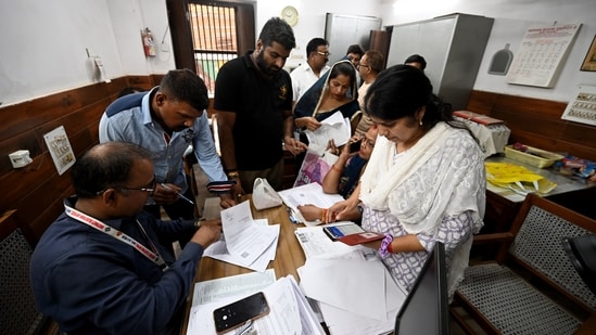 Voters arrive at a voter center to seek clarification and make correction to their SIR Forms at Laxmi Devi School Sadar Bazar, in New Delhi.