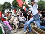 Protesters breach the security barricades during the All India Students' Association (AISA)- and Revolutionary Youth Association (RYA)-led Lok Bhawan March demanding the Chief Election Commissioner Gyanesh Kumar's resignation over alleged irregularities in electoral rolls, in Patna on Tuesday.