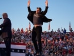 FILE - Elon Musk jumps on the stage as Republican presidential nominee former President Donald Trump speaks at a campaign rally at the Butler Farm Show in Butler, Pa., on Oct. 5, 2024