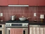 Content creator Angelie just turned her rental kitchen into a chic burgundy haven using DIY, renter-friendly hacks. (Instagram/ casa.angelie)