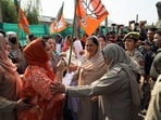 Security personnel stop BJP workers during a protest against the Congress near its office in Srinagar on Monday. (ANI)