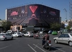 Vehicles drive past a huge billboard depicting Israeli Prime Minister Benjamin Netanyahu speaking at the U.N. General Assembly while seats are empty, referring to some delegations leaving the hall during his address in September, at the Islamic Revolution Square in Tehran, Iran, Monday, Oct. 12, 2026.(AP Photo)