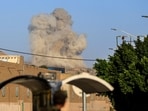A plume of smoke rises during a reported airstrike by the Saudi-led coalition on the Houthi-controlled Yemeni capital Sanaa, on October 9, 2026. 
