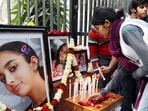 In this file photo friends and relatives of Aarushi Talwar light candles near her portrait to seek justice for her at Jantar Mantar in New Delhi in Jan 2011.