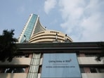 A screen displays a message of the National Stock Exchange (NSE) listing ceremony at the Bombay Stock Exchange (BSE) in Mumbai on September 24